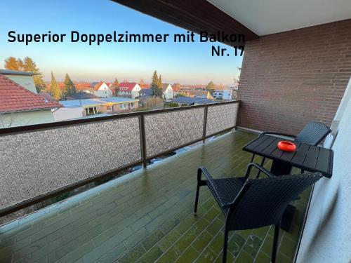 a balcony with a table and two chairs on it at HoteLPension am Thermalbad in Bad Nenndorf