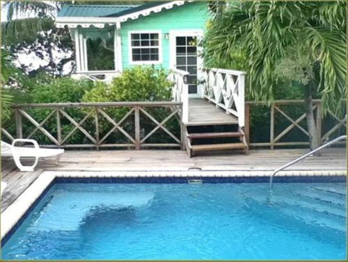 a house with a swimming pool in front of a house at Apartment Espoir in Castries