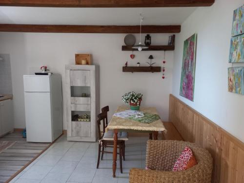 a kitchen with a table and a refrigerator at L'armonica di nonnoSandro in Corfinio