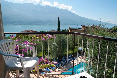 a balcony with a chair and a view of a mountain at Hotel Garden in Limone sul Garda