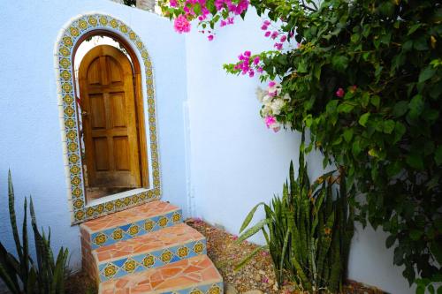 a door with a mirror on the side of a house at Hotel Casamar Suites in Puerto Escondido