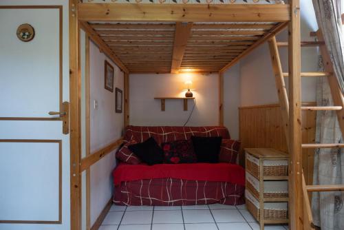 a living room with a red couch in a room at Studio en centre village St Gervais in Saint-Gervais-les-Bains