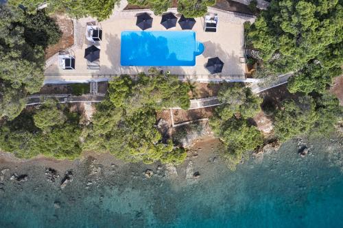 an aerial view of a house and the ocean at Xenia Poros Image Hotel in Poros