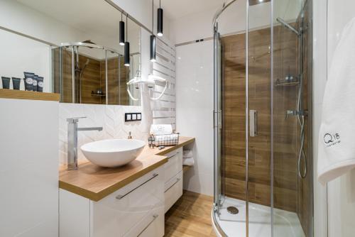 a bathroom with a sink and a shower at Q18 ApartHotel in Bydgoszcz