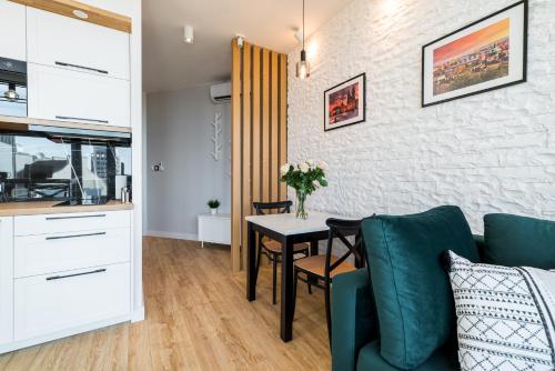 a living room with a table and a couch at Q18 ApartHotel in Bydgoszcz