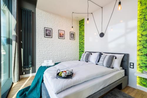 a bedroom with a bed with a bowl of fruit on it at Q18 ApartHotel in Bydgoszcz