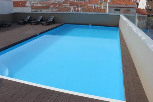 a swimming pool with a blue floor and blue walls at Apartamentos Turisticos da Nazare in Nazaré