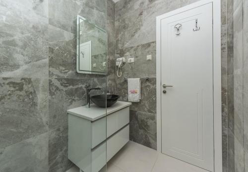 a bathroom with a sink and a mirror at Villa Božica - sea view stone villa with free parking in Makarska
