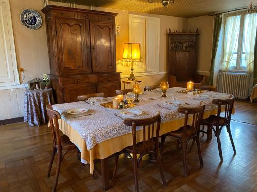 a dining room with a table with candles on it at Hôtel de famille L.F.M.A.L. in Giat