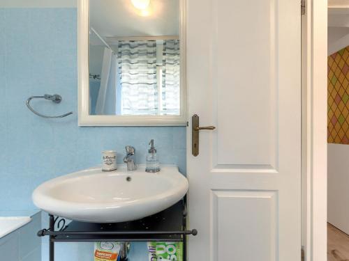a bathroom with a sink and a mirror at Holiday Home Centar by Interhome in Umag