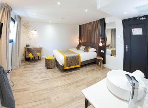 a hotel room with a bed and a bathroom at Le Confidentiel Hôtel & SPA in Saint-Raphaël