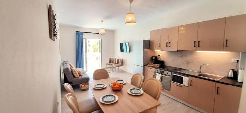 a kitchen with a table and a dining room at The Central Villa - Kassiopi Corfu Villas in Kassiopi