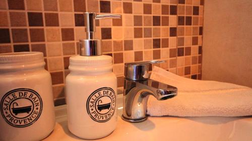 a bathroom sink with a bottle of soap and a faucet at Country House Dajkovic in Dupilo