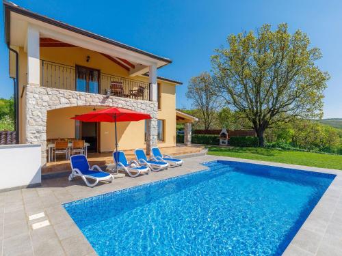 a villa with a swimming pool and a house at Holiday Home Panorama 1 by Interhome in Labin