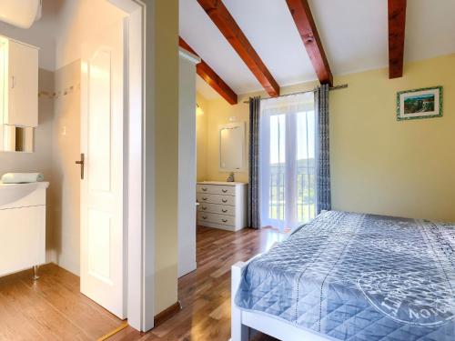 a bedroom with a bed and a dresser and a window at Holiday Home Panorama 1 by Interhome in Labin
