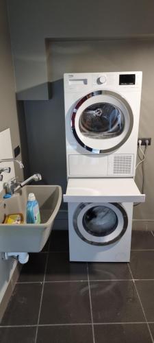 a washing machine and a washer in a bathroom at Metropolis Apartamenty Centrum in Kalisz