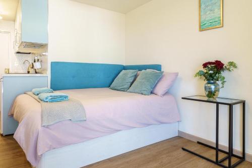 a bed with a blue headboard in a room at Calypso in Sitio de Calahonda