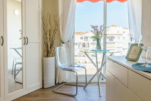 a kitchen with a table and chairs and a window at Calypso in Sitio de Calahonda