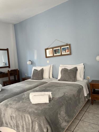 a large bed with a white towel on top of it at Olympic Villas in Oia