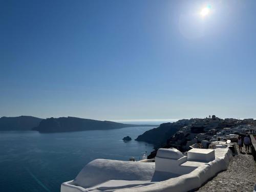 a view of the ocean from the side of a cliff at Olympic Villas in Oia