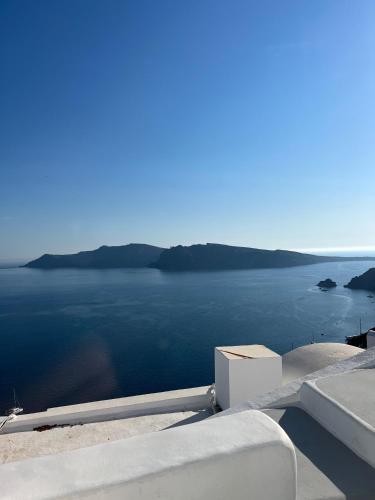 a view of a body of water from a house at Olympic Villas in Oia