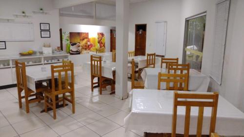a kitchen and dining room with a table and chairs at Hotel Vale do Sol in Votuporanga