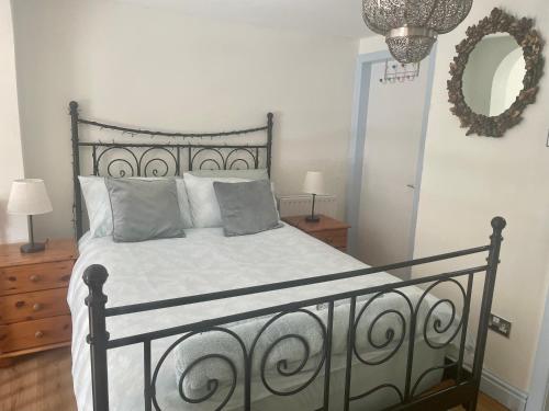 a bedroom with a bed with white sheets and pillows at Windsor View, great views, walkers paradise, dog friendly in Hebden Bridge