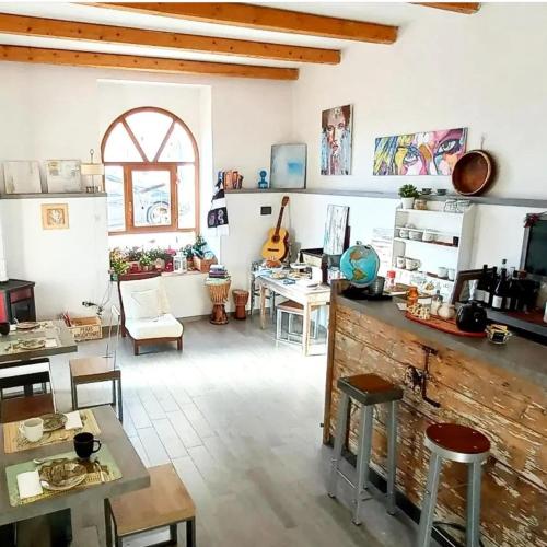 a living room with a table and chairs and a desk at L'armonica di nonnoSandro in Corfinio
