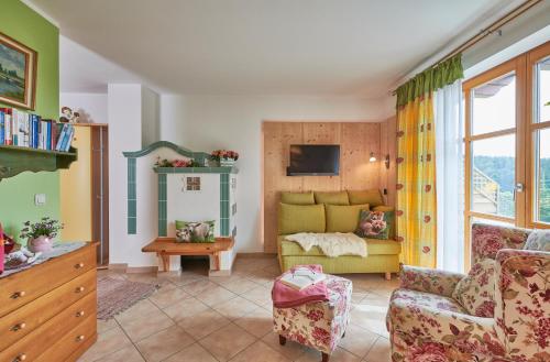a living room with a couch and a table at Zum Sonnenhuegel in Wegscheid