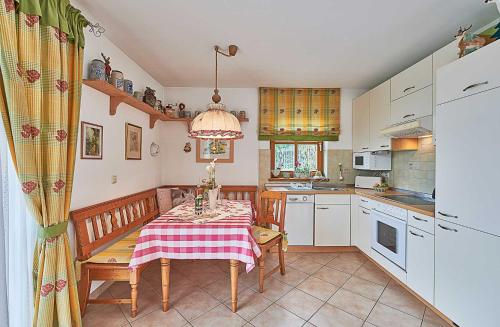 a kitchen with a table and a dining room at Zum Sonnenhuegel in Wegscheid