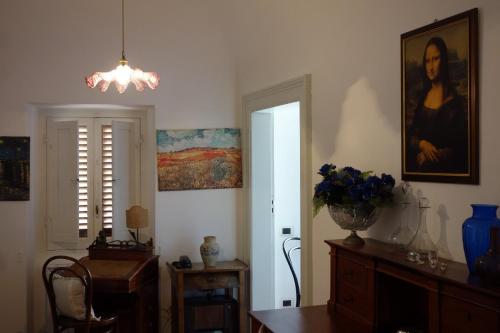 a room with a table and a painting on the wall at Antica Dimora Fuori Le Mura B&B in Scanno