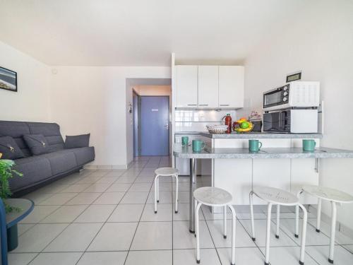 Il comprend une petite cuisine et un salon avec un canapé. dans l'établissement Apartment Copacabana-21 by Interhome, à Canet