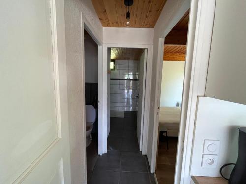 a hallway leading to a bathroom in a house at Barcelonnette location avec jardin in Barcelonnette