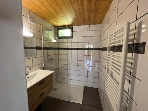 La salle de bains est pourvue d'un lavabo et d'un miroir. dans l'établissement Barcelonnette location avec jardin, à Barcelonnette