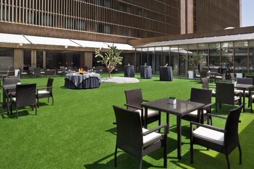 a group of tables and chairs on a field of grass at Melia Lebreros in Seville