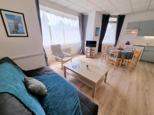 a living room with a couch and a table at Apartment Le Petit Robinson-5 by Interhome in La Richardais