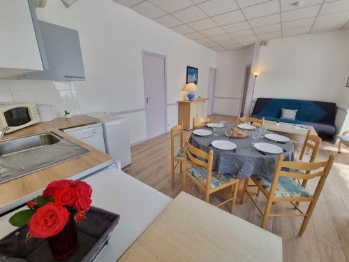 a kitchen and dining room with a table and chairs at Apartment Le Petit Robinson-5 by Interhome in La Richardais