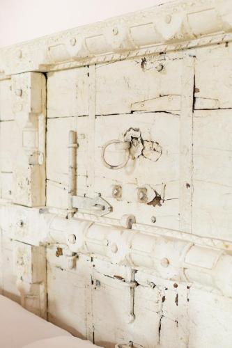 a white wooden wall with a bunch of things on it at Ancient Lore Village in Knoxville