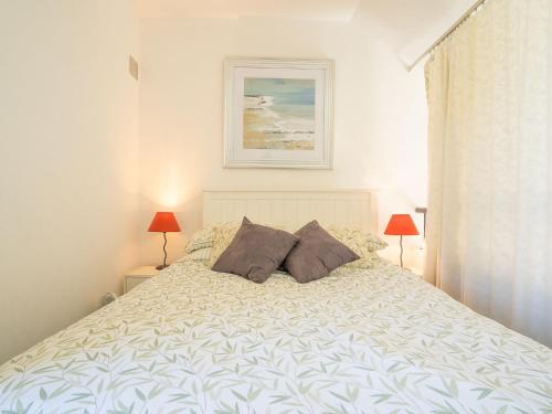 a bedroom with a large bed with two pillows at Holiday Home Villas Plein Soleil 1 by Interhome in La Grande Motte