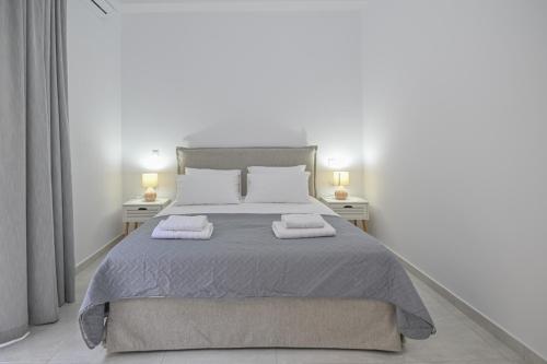 a bedroom with a bed with two towels on it at Moka Apartments in Chania Town