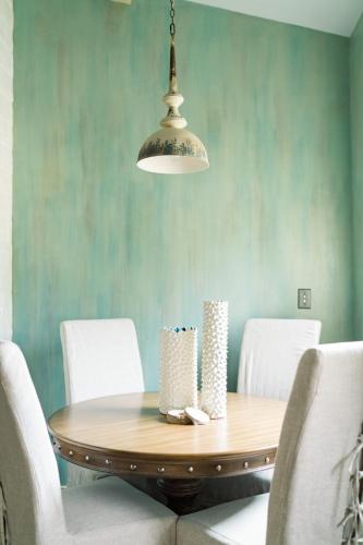 a dining room with a wooden table and white chairs at Ancient Lore Village in Knoxville