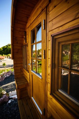 a wooden door of a log cabin with windows at Complex Butoaiele Transilvaniei - Cazare & SPA - Natura - Relaxare in Mediaş