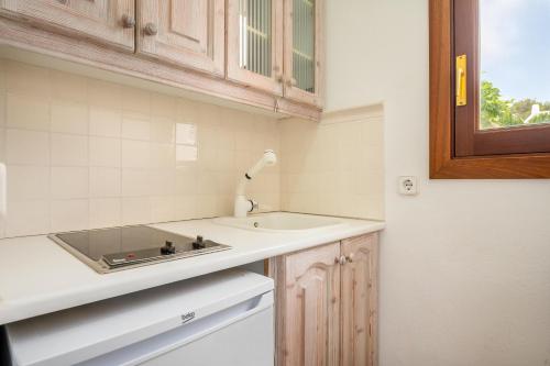 a small kitchen with a sink and a counter at Wonderful 5 Bed Villa With Private in Cacla D'or