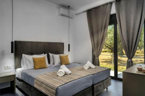 a bedroom with a large bed with pillows on it at ALFI'S HOUSE LITHAKIA ZAKYNTHOS in Lithakia