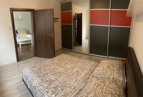 a bedroom with a bed and a large mirror at Byt Marie 10min to the square in České Budějovice