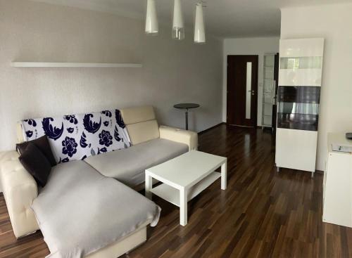 a living room with a couch and a table at Byt Marie 10min to the square in České Budějovice