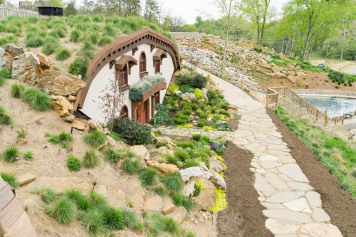 a garden with a small house and a swimming pool at Ancient Lore Village in Knoxville