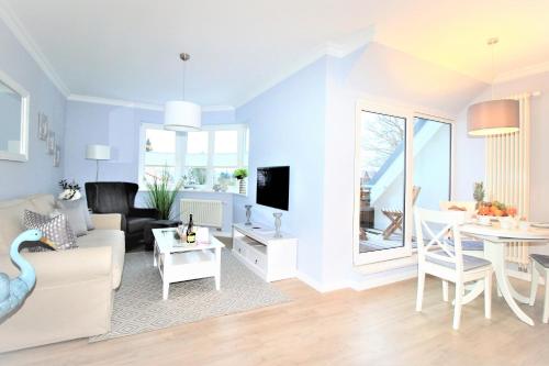 a living room with a couch and a table at KranichSuite - Zingst in Zingst