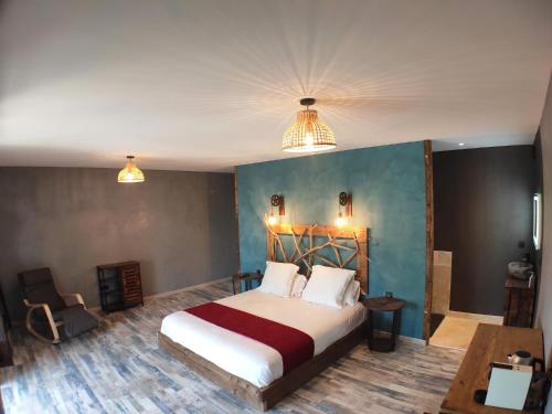 a bedroom with a large bed and two lights at Villa Occitana in Calvisson