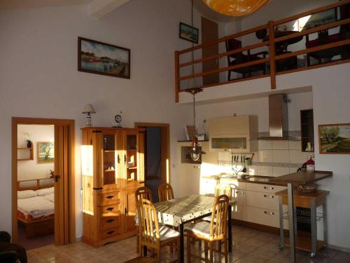 a kitchen and dining room with a table and chairs at Fewo De luette Moew_KOC in Ostseebad Karlshagen